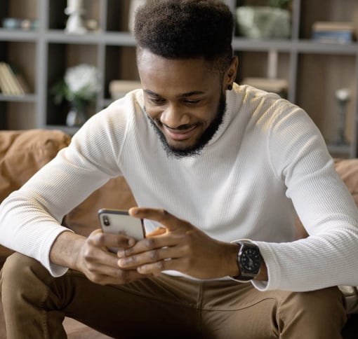 Young man looking texting at his phone